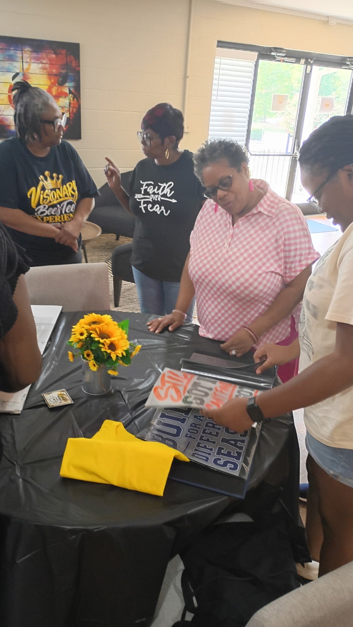 Guests choosing shirt designs during a Bee's Tees Experience event